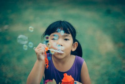 Three to Five year old blowing bubbles