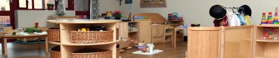 A playroom filled with lots of wooden furniture