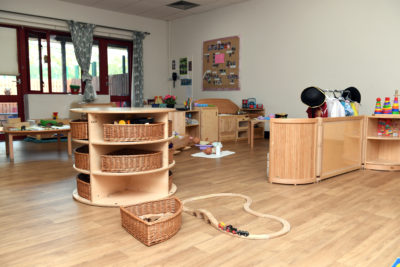A playroom with a wooden table and a toy train